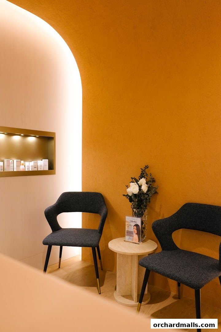 Waiting area with chairs, a side table, flowers, and product display at SkinLab The Medical Spa.