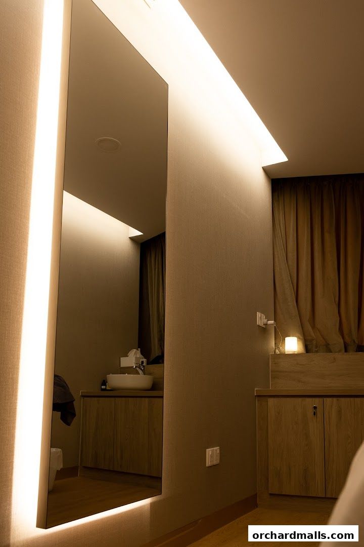 Interior of a medical spa with a large illuminated mirror and a sink area.