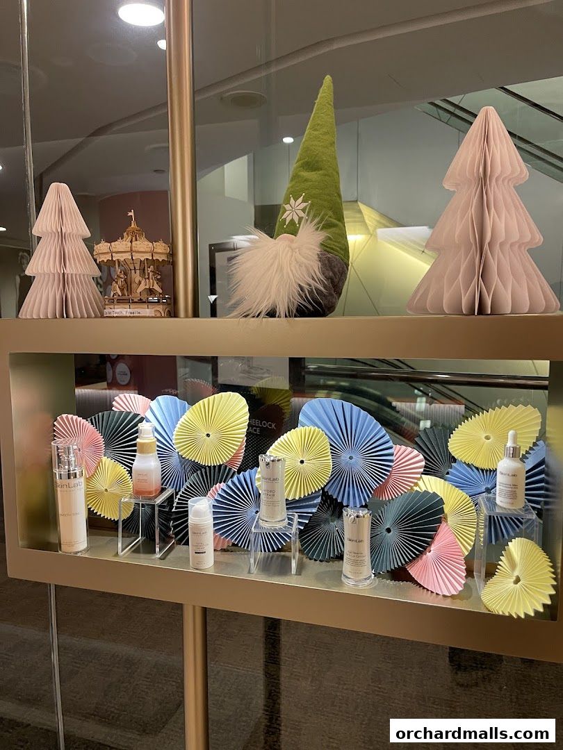 A shop window display featuring skincare products and festive decorations.
