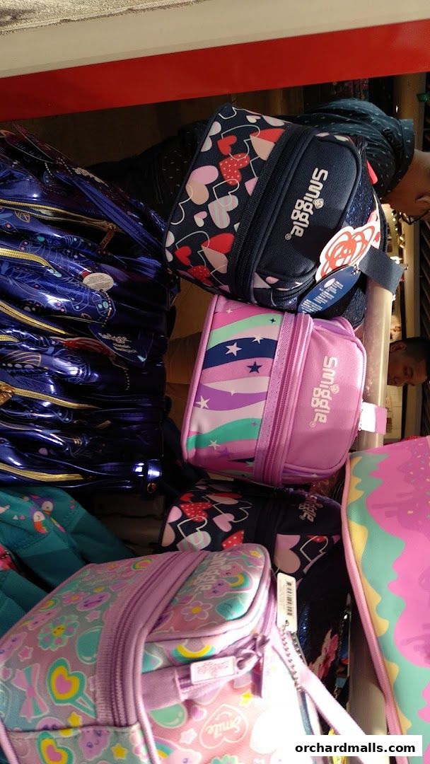 A colorful display of Smiggle bags with various playful patterns and designs.