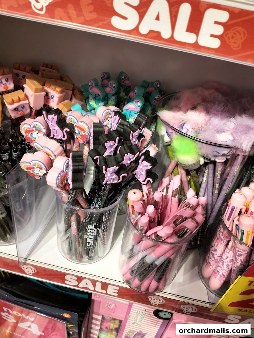 A display of colorful pens and stationery items, many with fun character designs, on sale.