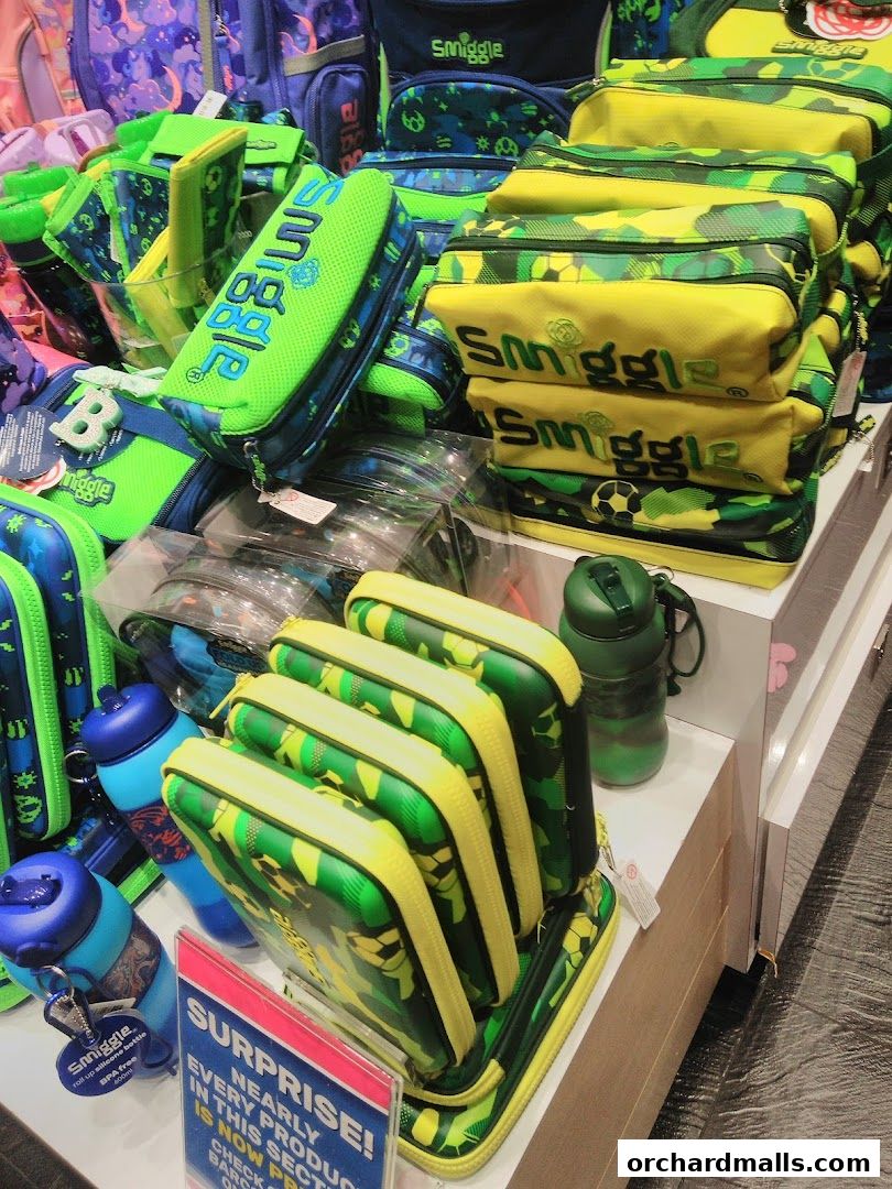 A display of colorful Smiggle stationery and accessories, including pencil cases and water bottles.