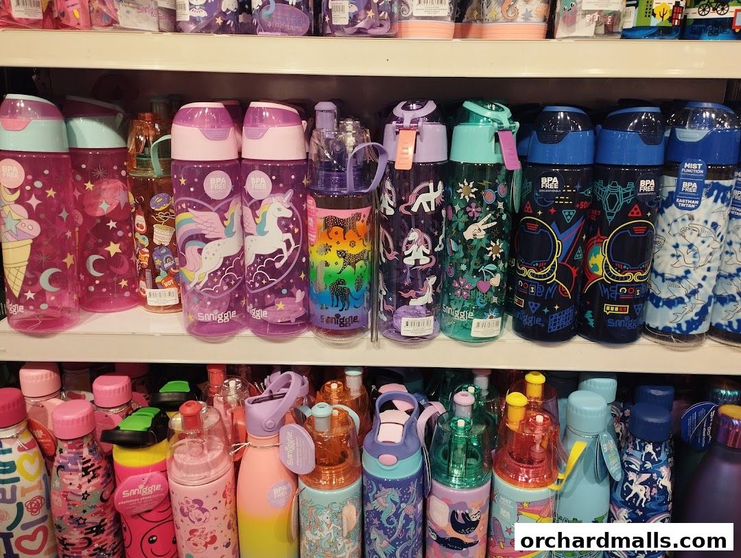 A display of colorful and patterned water bottles on shelves, featuring unicorns, astronauts, and other fun designs.