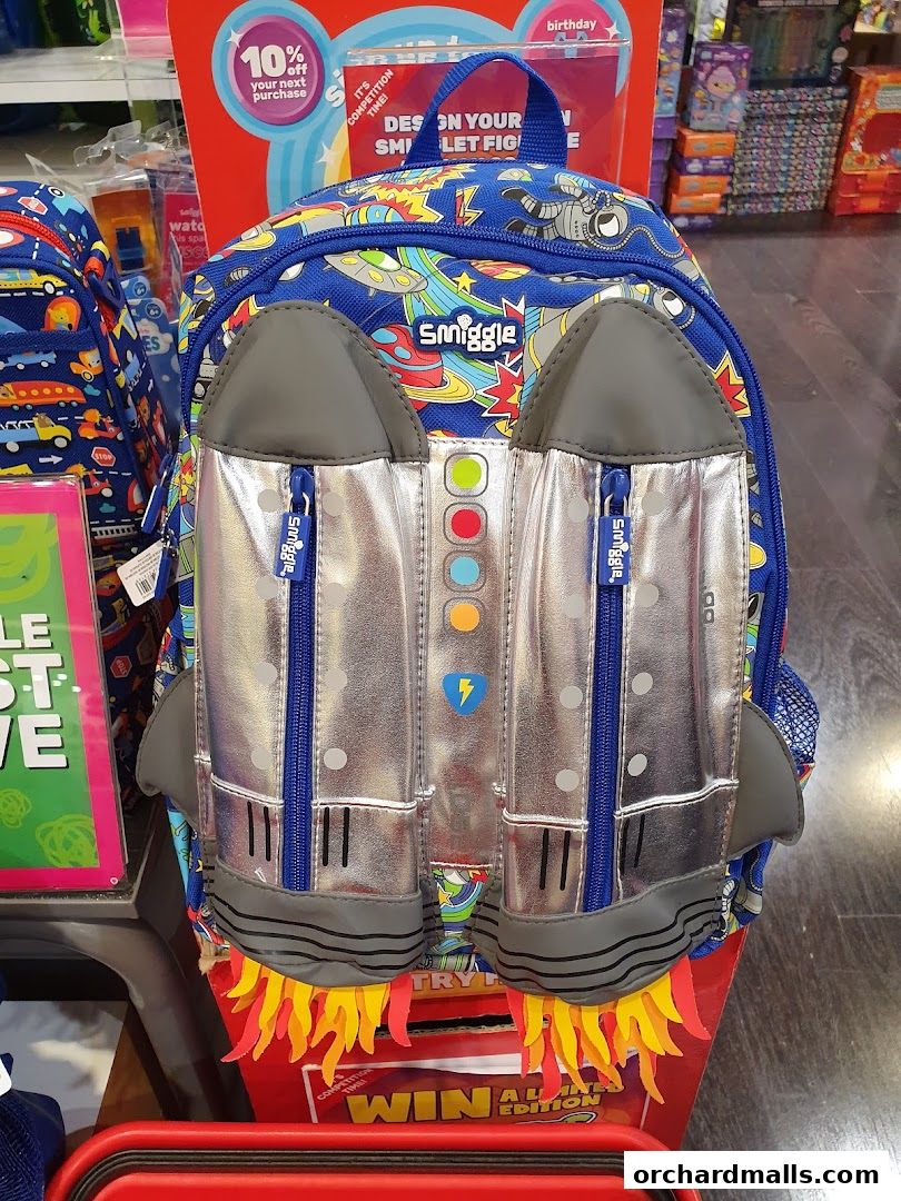 A Smiggle backpack designed like a rocket with a space-themed print and flame details.