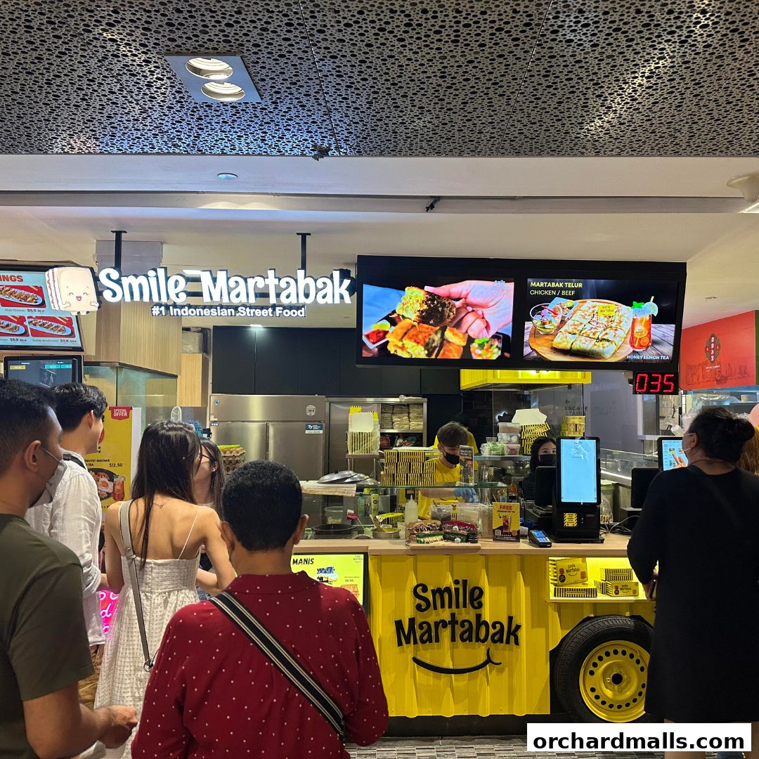 Customers queue at Smile Martabak, an Indonesian street food stall in a mall.