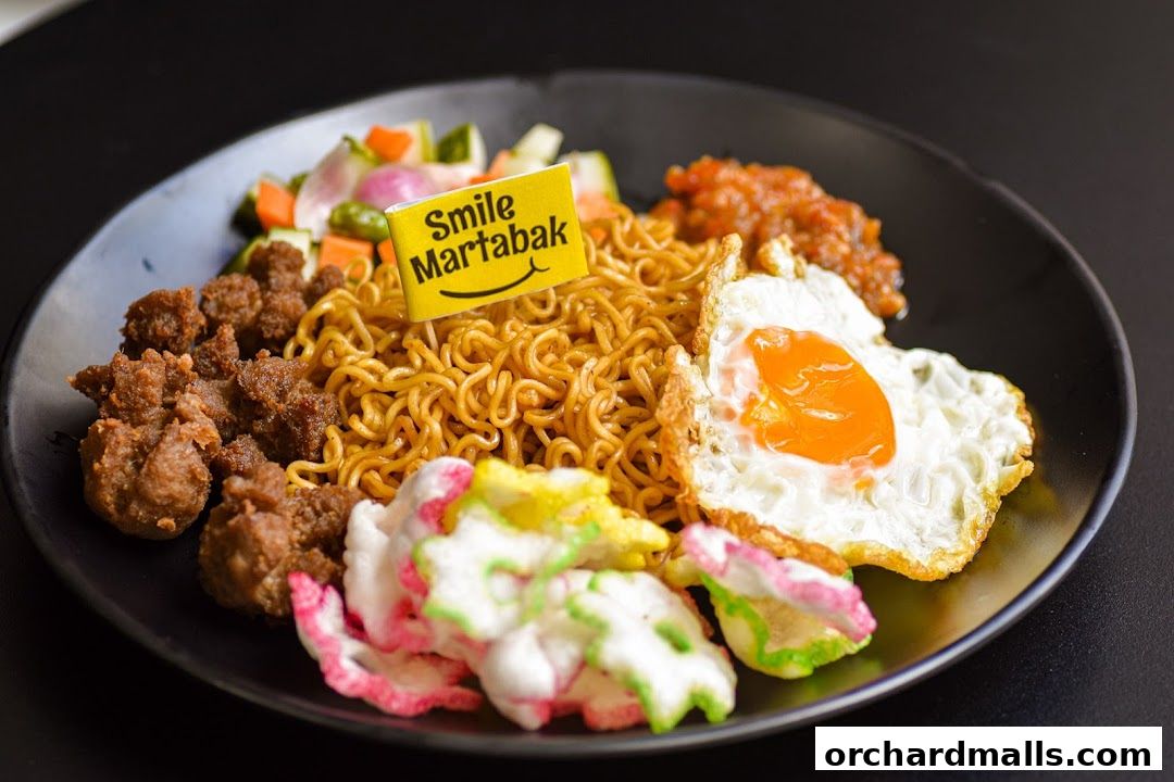 A plate of savory noodles with fried egg, meat, and crackers, branded with Smile Martabak.