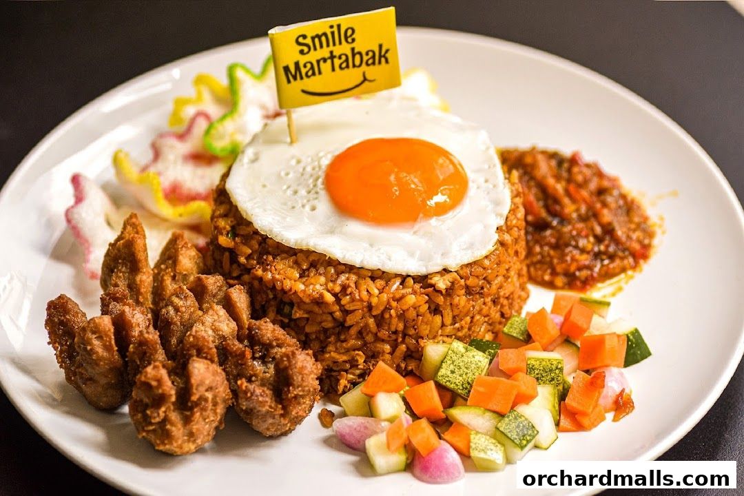A plate of nasi goreng with fried egg, fried chicken, and sambal, topped with a Smile Martabak flag.