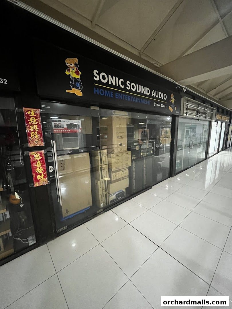 Exterior view of Sonic Sound Audio, a home entertainment store, showcasing products through its glass facade.