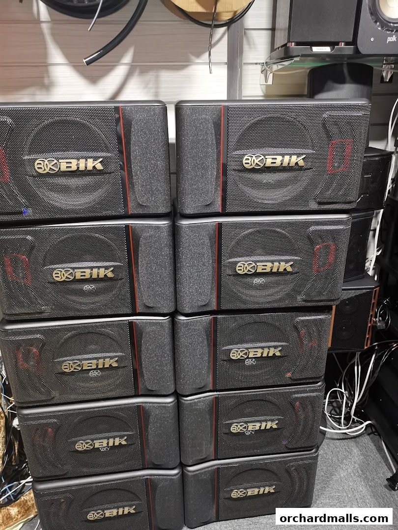 A stack of black audio speakers with the 'BK BIK' logo.