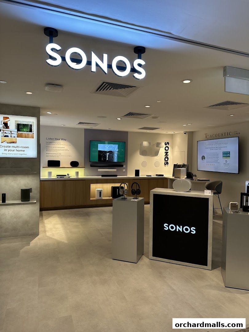 Interior of a modern Sonos store showcasing audio products and displays.
