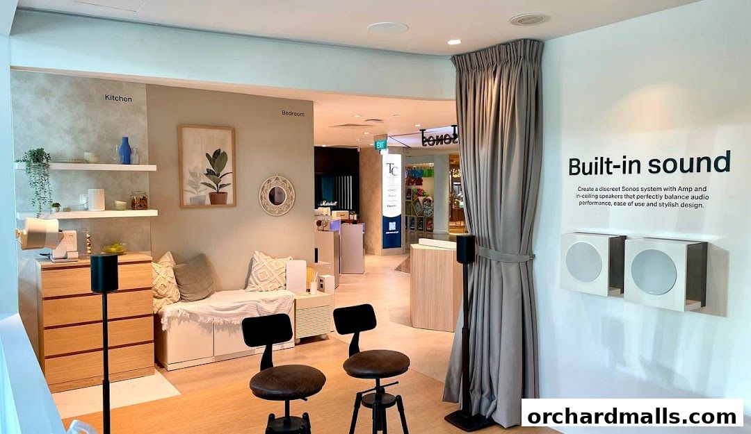 Interior of a Sonos store showcasing built-in sound systems in kitchen and bedroom settings.