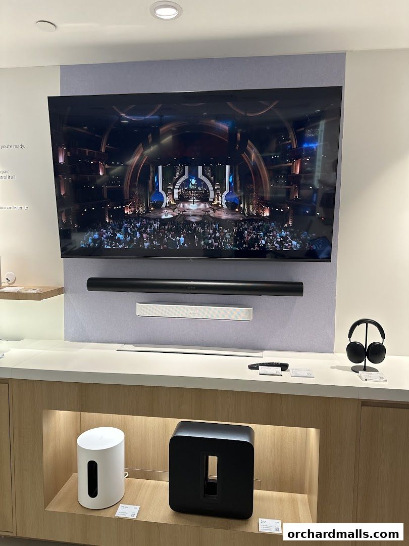 Sonos soundbars, subwoofers, and headphones displayed in a modern retail store.