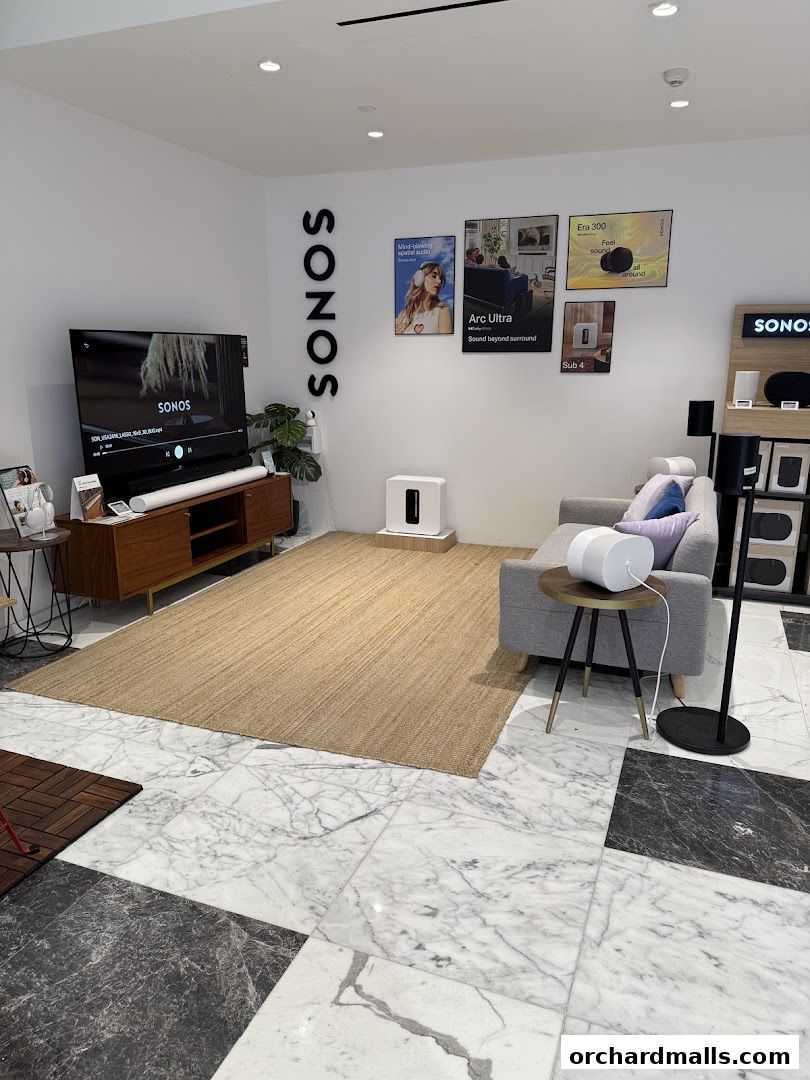 Interior of a Sonos store showcasing home audio systems and a comfortable living room setup.
