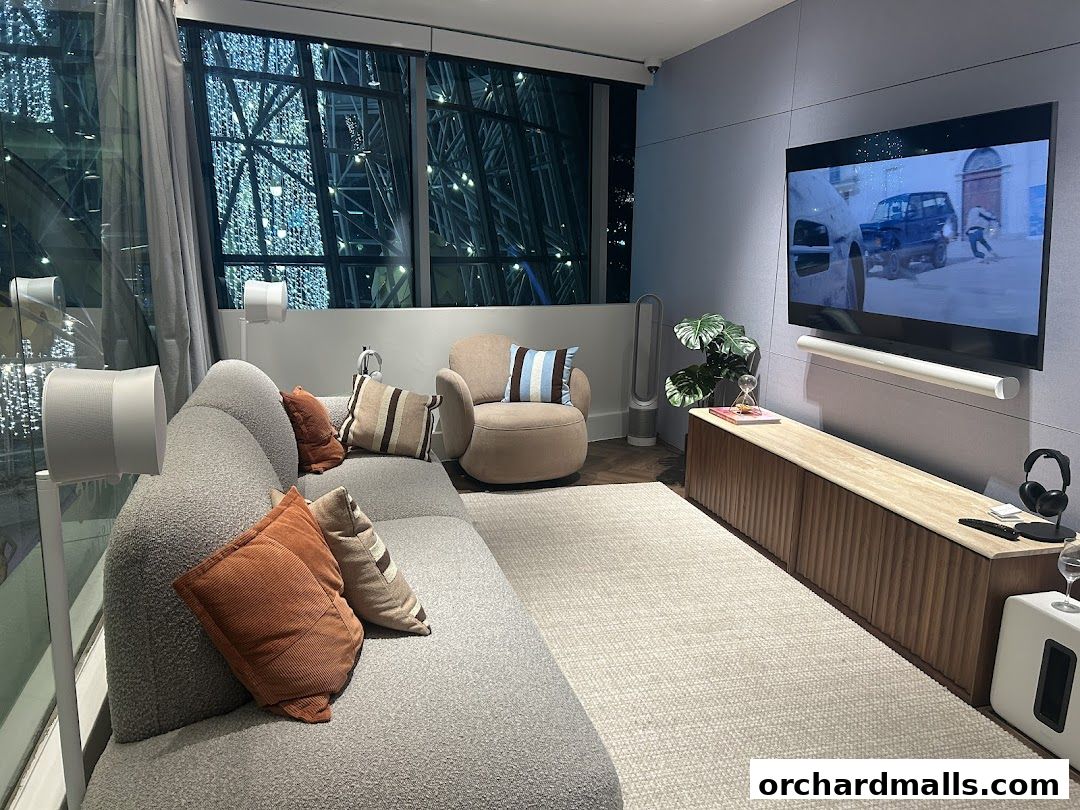 A modern living room setup with Sonos audio equipment and a large television.