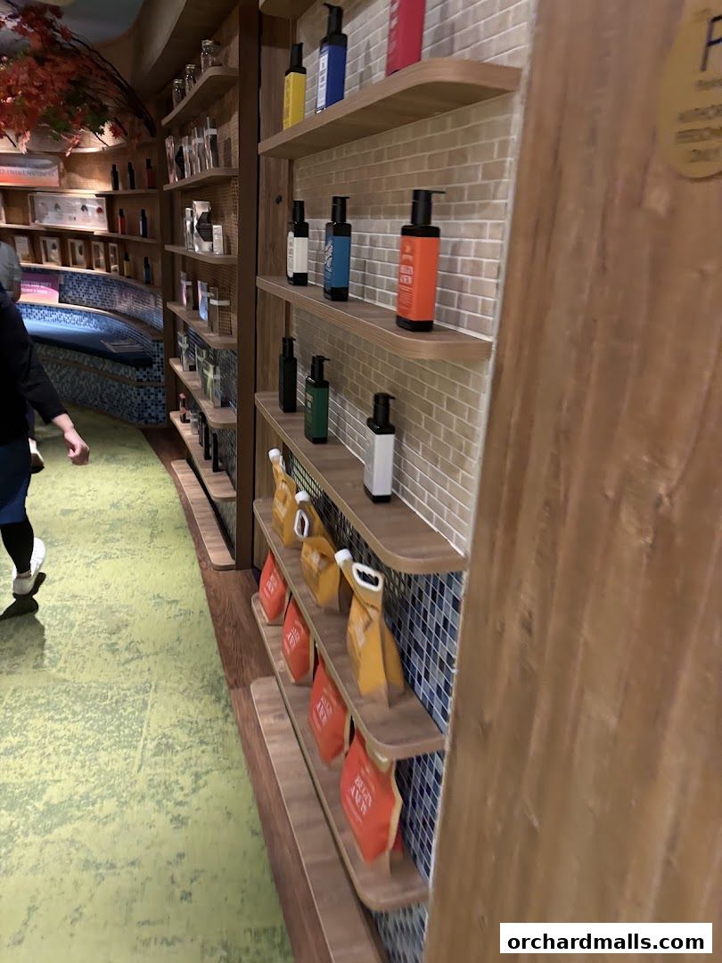 Shelves stocked with various spa products and bottles in a retail store.