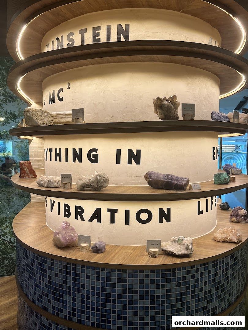 A multi-tiered display of crystals and minerals with inspirational text.