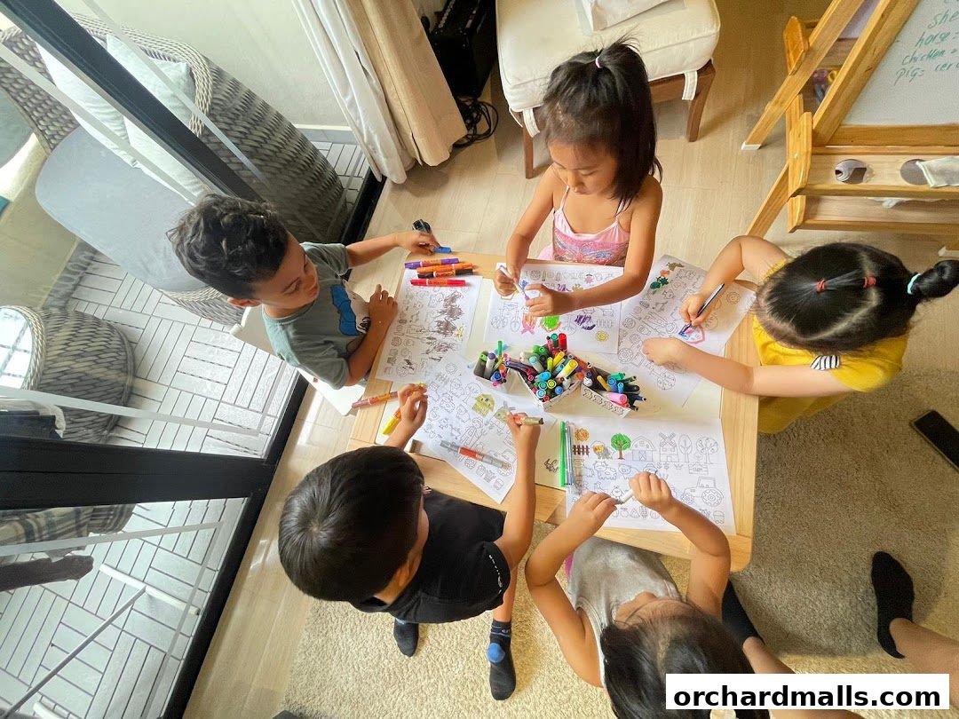 Children are coloring pictures at a table with markers and coloring pages.