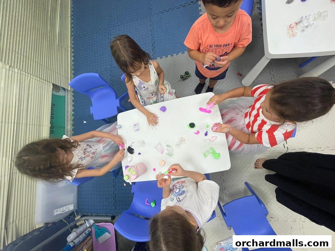 Children engaged in a creative activity with colorful modeling clay at tables.