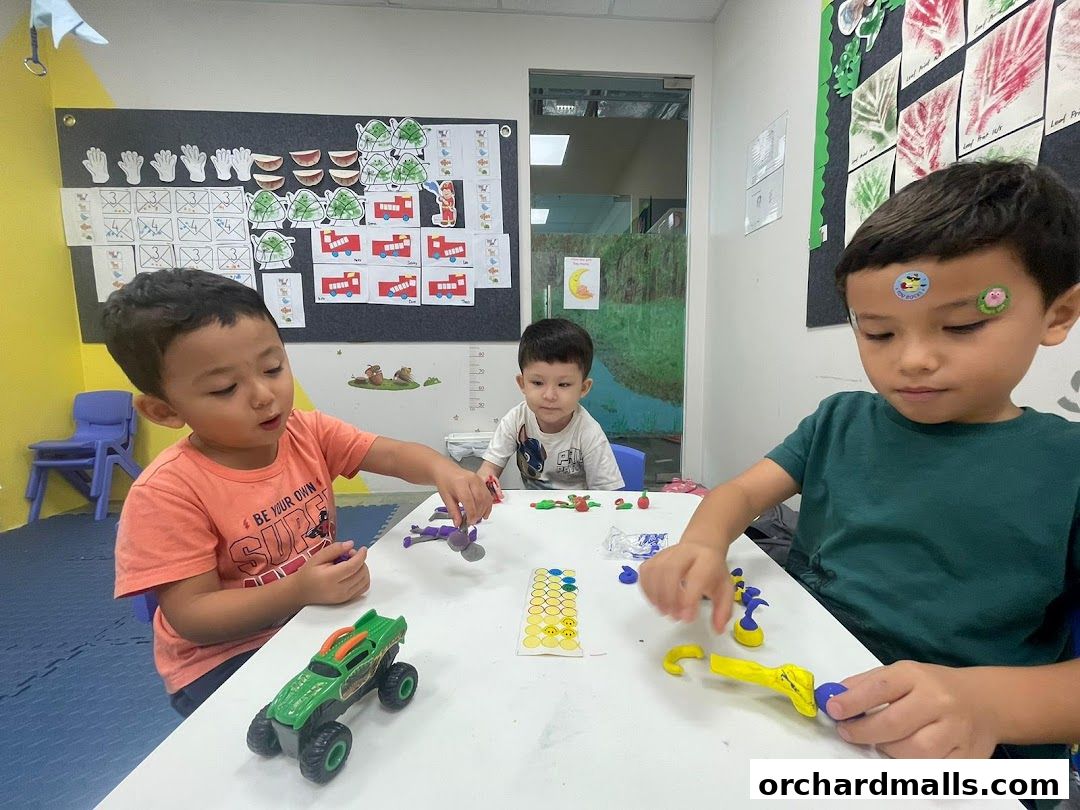 Children engaged in a creative activity with colorful playdough at a table.