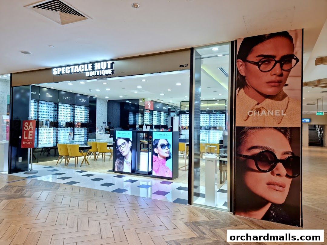 Spectacle Hut Boutique storefront featuring designer eyewear displays and large fashion advertisements.