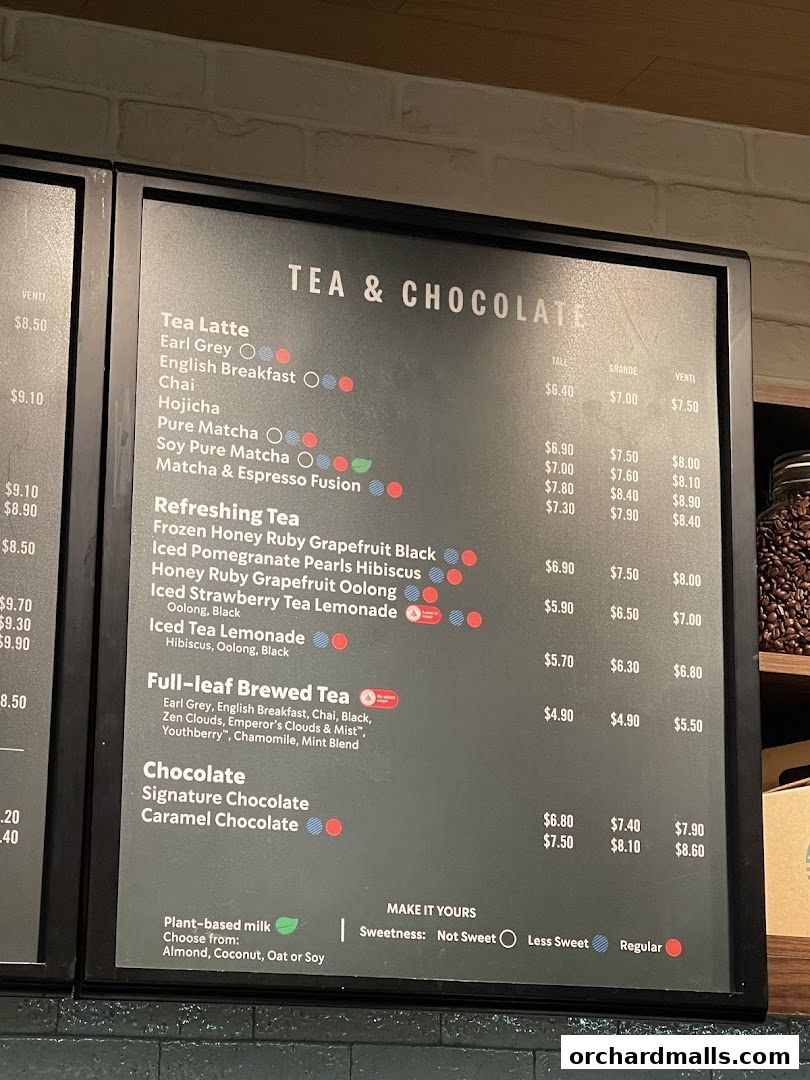 A menu board displaying Starbucks' tea and chocolate beverages with prices.