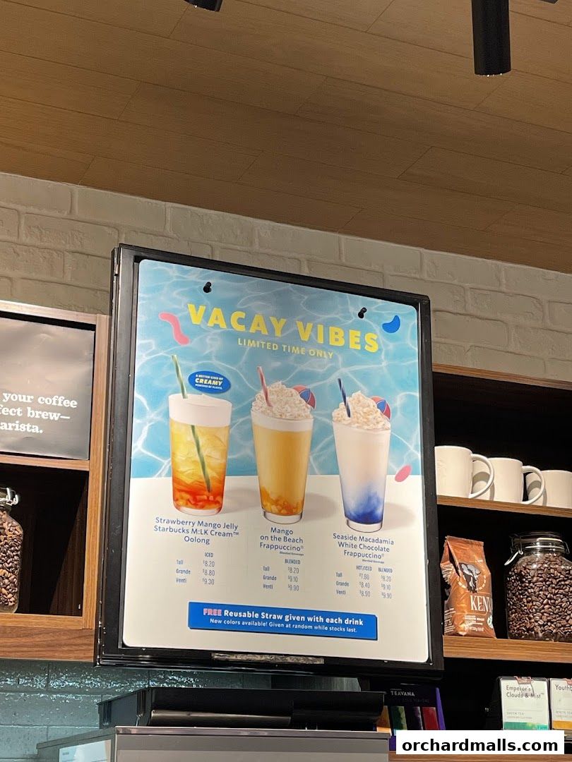 Starbucks menu board displaying three limited-time 'Vacay Vibes' drinks with prices.