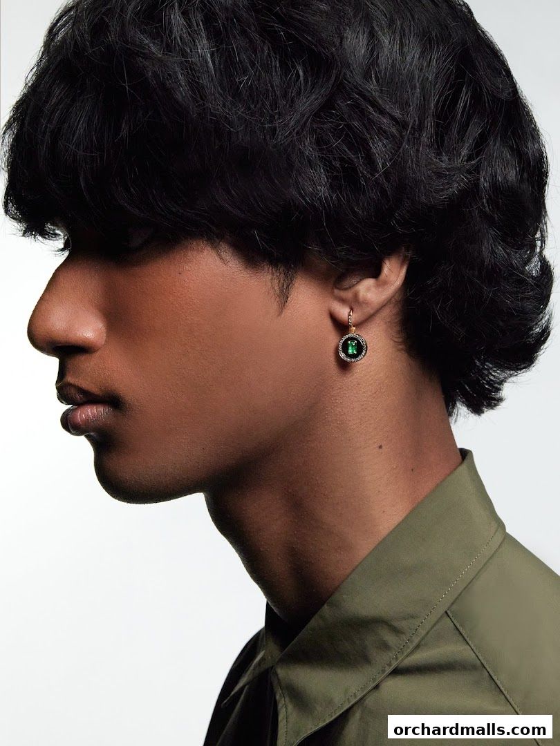 Close-up profile of a person wearing an emerald earring from State Property.
