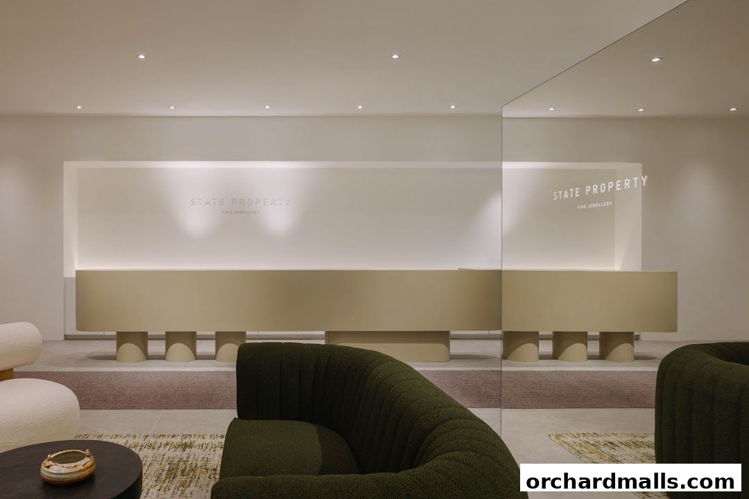 Interior of a modern jewelry store with a reception desk and seating areas.