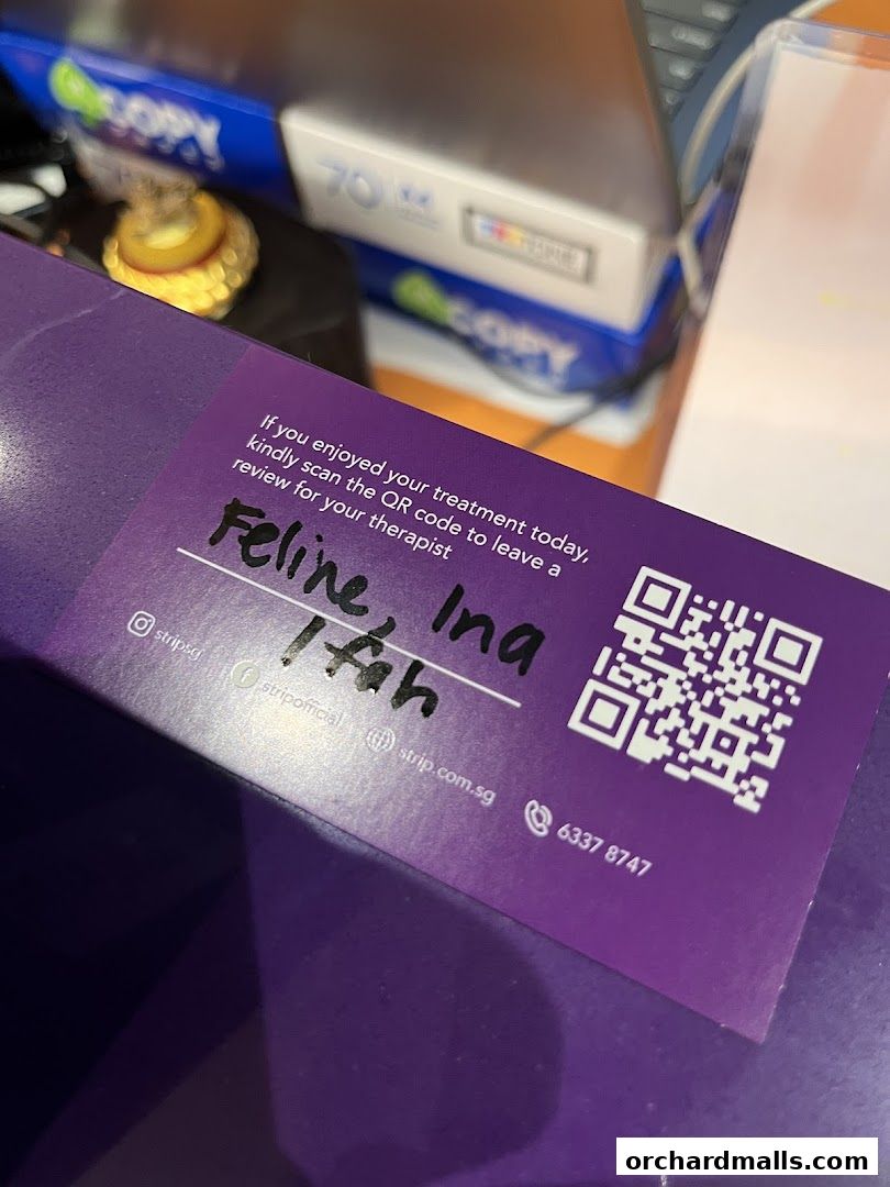 A purple card with a QR code and handwritten text about a therapist review.