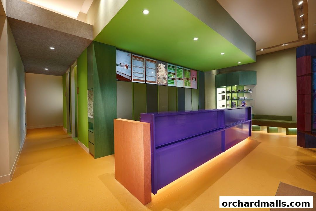 Interior view of a modern shop with a purple reception desk and colorful walls.