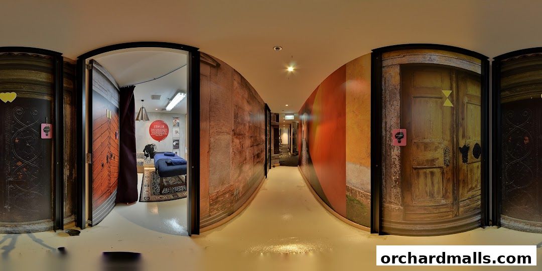 Interior hallway of a spa with treatment rooms and decorative doors.