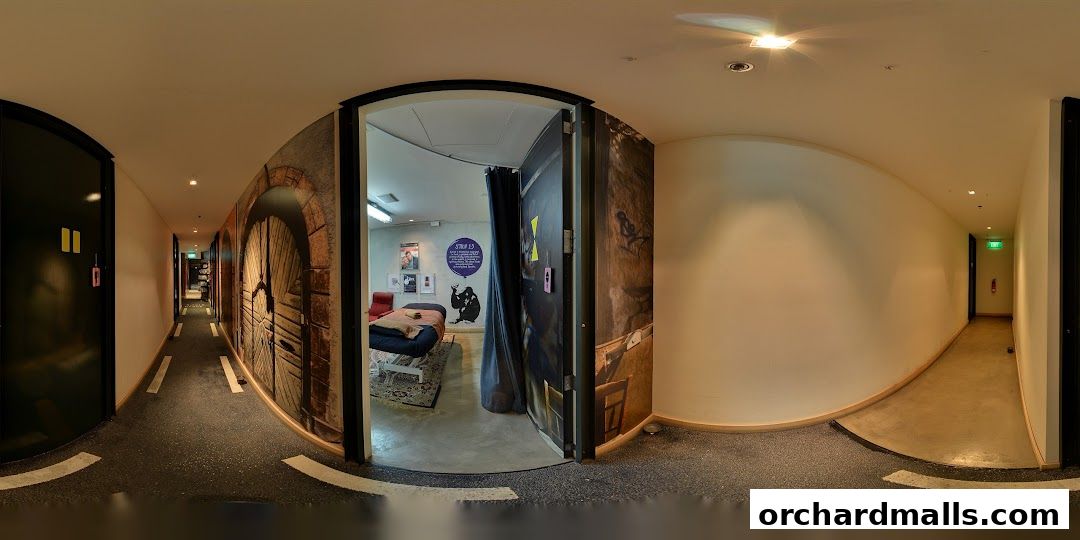 Interior view of a spa hallway with a treatment room visible.
