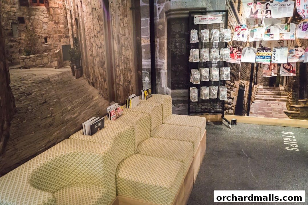 A waiting area with a modular sofa, magazines, and a display of strip care products.