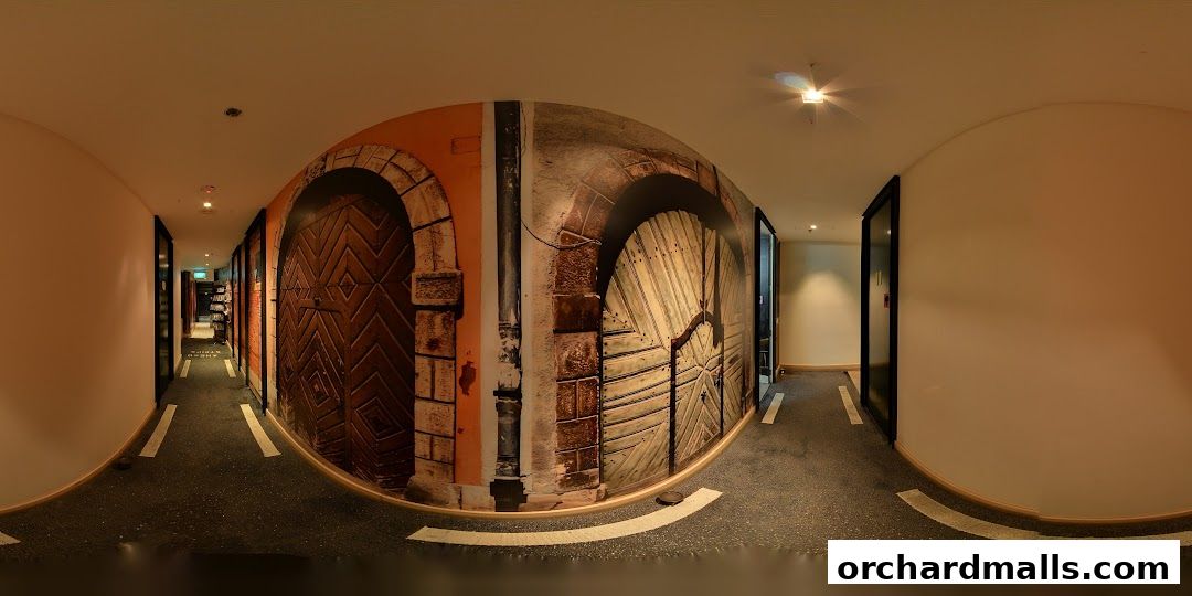 A hallway with a mural of old wooden doors and brickwork.