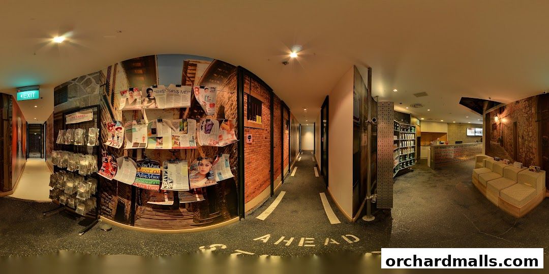 Interior view of a shop with magazines, products, and a reception area.