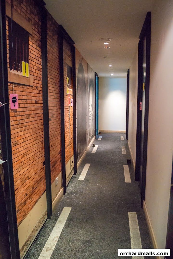 A hallway with brick wall murals and road markings on the floor.