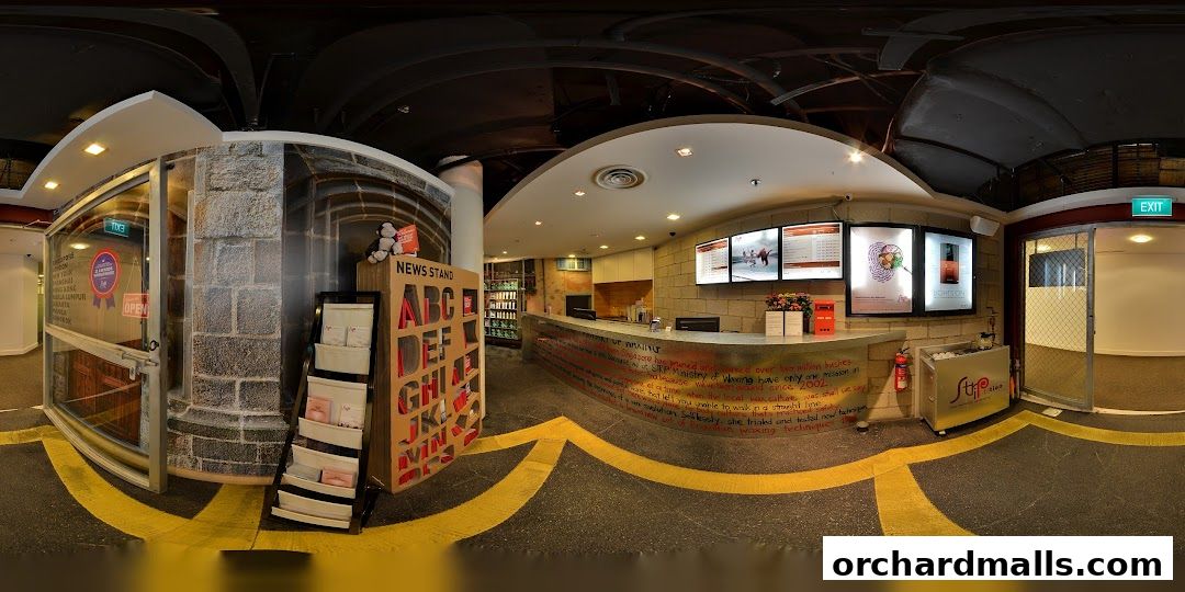 The entrance and reception area of Strip Co-Ed Wheelock, featuring a news stand and service counter.