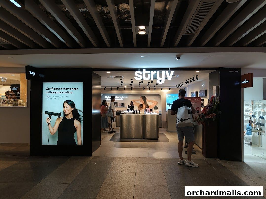 The Stryv shop front with a large advertisement featuring a woman holding a hairdryer.
