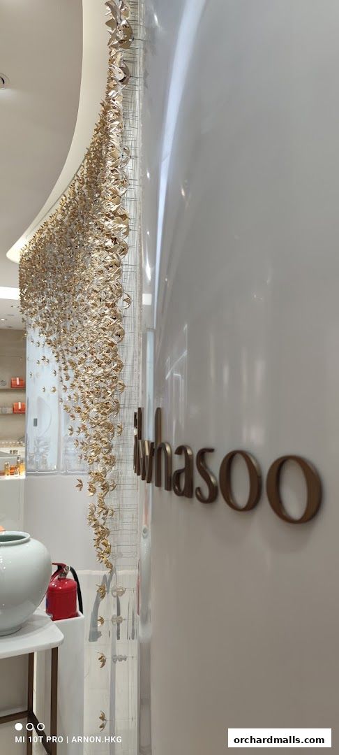 Sulwhasoo boutique interior with elegant gold floral decor and branding.