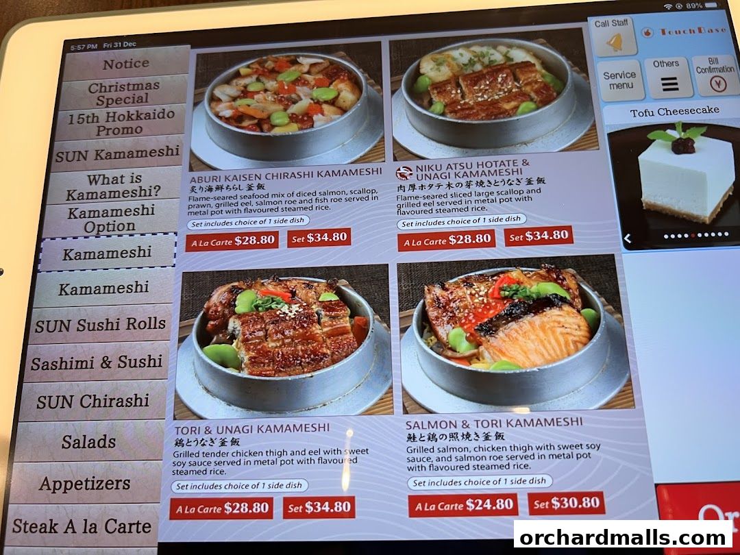 A digital menu displaying various Japanese dishes, primarily Kamameshi, with prices and descriptions.