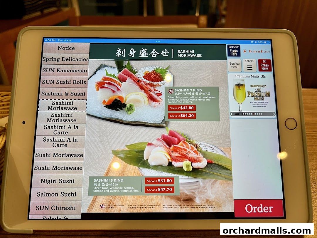 A tablet displays a Japanese restaurant's menu with sashimi options and prices.