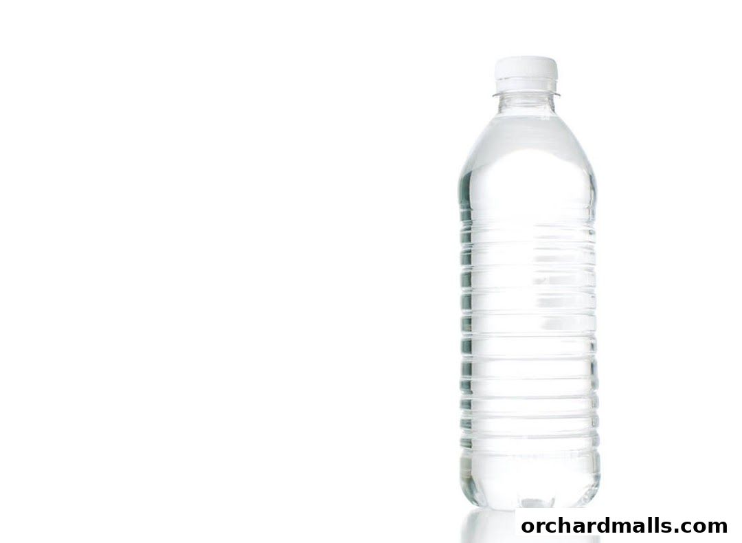 A clear plastic bottle filled with water, isolated on a white background.