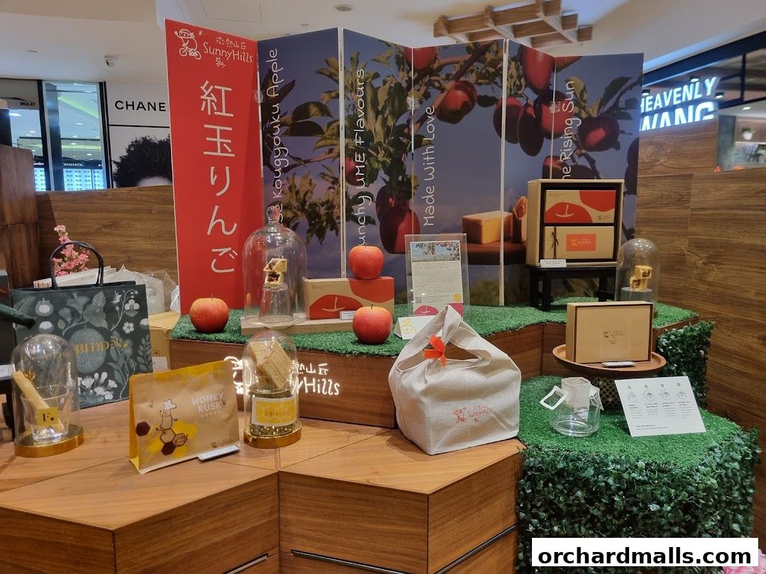 A display of SunnyHills Orchard products, featuring apples, gift boxes, and baked goods.
