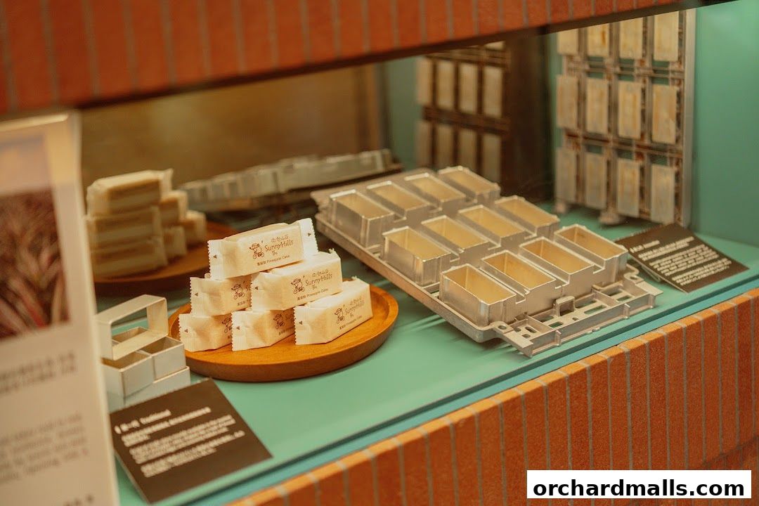 SunnyHills Orchard display featuring individually wrapped pineapple cakes and baking molds.
