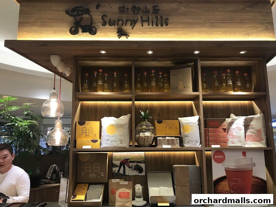 SunnyHills Orchard shop interior with products displayed on wooden shelves.