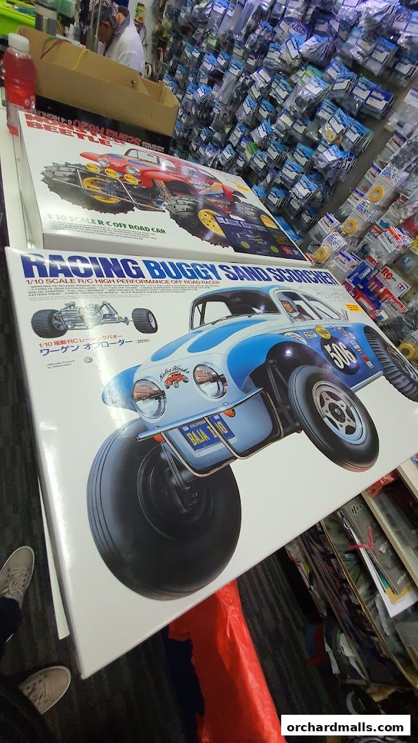 RC car model boxes and shelves stocked with parts in a hobby shop.