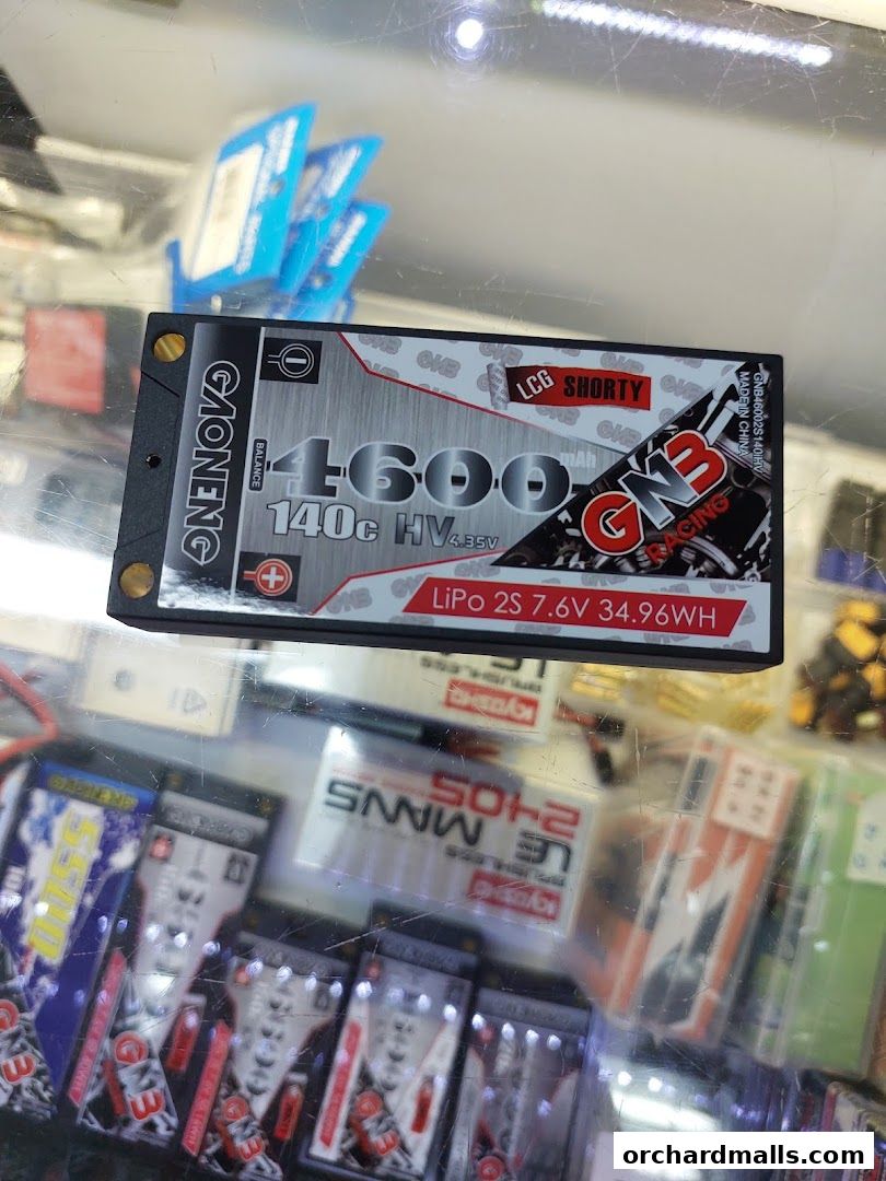 A close-up of a LiPo battery with 'GNB Racing' branding, displayed in a retail setting.