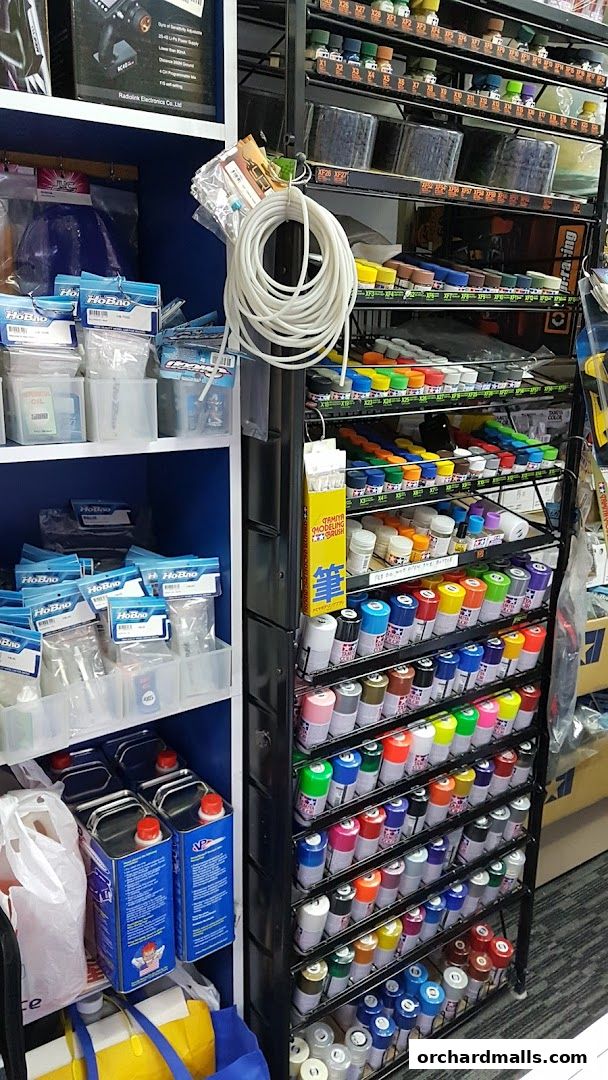 Shelves stocked with model paints, accessories, and supplies for hobbyists.