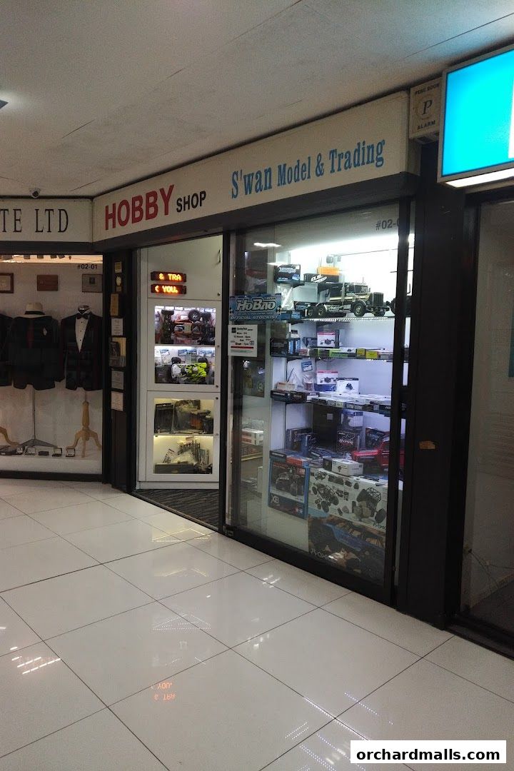 Exterior view of Swan Model & Trading hobby shop with display windows showcasing models.