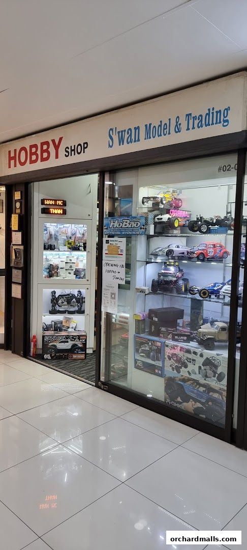 Exterior of Swan Model & Trading hobby shop displaying various model cars and accessories.